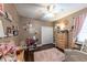 Charming bedroom featuring stylish decor, a ceiling fan, and wood-look flooring, offering a cozy and inviting atmosphere at 697 Broadoak Loop, Sanford, FL 32771