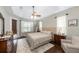 Bright bedroom with hardwood floors, a comfortable bed, and ample natural light at 697 Broadoak Loop, Sanford, FL 32771