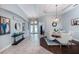 Elegant dining room with a stylish chandelier, neutral decor, and a view of the front entrance at 697 Broadoak Loop, Sanford, FL 32771