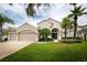 Beautiful single-Gathering home featuring a well-manicured lawn, mature trees, and a two-car garage at 697 Broadoak Loop, Sanford, FL 32771