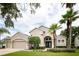 Charming single-Gathering home with lush landscaping, manicured lawn, and a welcoming front entrance at 697 Broadoak Loop, Sanford, FL 32771