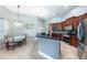 Spacious kitchen with wooden cabinetry and a cozy dining area with natural light at 697 Broadoak Loop, Sanford, FL 32771