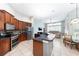 Open kitchen with stainless steel appliances, dark countertops, and adjacent breakfast nook at 697 Broadoak Loop, Sanford, FL 32771