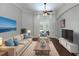 Inviting living room with modern decor, hardwood floors, and large windows providing ample natural light at 697 Broadoak Loop, Sanford, FL 32771