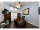 Well-lit home office featuring a large wooden desk and a ceiling fan at 697 Broadoak Loop, Sanford, FL 32771