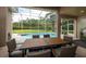 Outdoor dining area offering a view of the pool and landscaping, perfect for entertaining and relaxation at 697 Broadoak Loop, Sanford, FL 32771