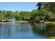 Scenic pond featuring a water fountain and tree lined walking path in the Lake Forest community at 697 Broadoak Loop, Sanford, FL 32771