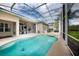 Screened-in pool and hot tub area, offering a relaxing outdoor retreat with dining and lounge space at 697 Broadoak Loop, Sanford, FL 32771