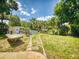 Expansive backyard featuring green grass, a fire pit, a picnic table, and an above-ground pool at 706 Lynn Ave, New Smyrna Beach, FL 32168