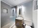 Modern bathroom with glass-enclosed shower, unique pebble floor, sleek vanity and vessel sink, offering a spa-like experience at 706 Lynn Ave, New Smyrna Beach, FL 32168