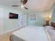 Bedroom with a large bed, window with blinds, and a television mounted on the wall, creating a cozy retreat at 706 Lynn Ave, New Smyrna Beach, FL 32168