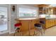 View of a breakfast bar with stools, connecting the kitchen to a bright, inviting outdoor living space at 706 Lynn Ave, New Smyrna Beach, FL 32168