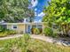 Charming single-story home with a well-maintained lawn, mature trees, and inviting curb appeal at 706 Lynn Ave, New Smyrna Beach, FL 32168