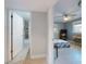 Hallway showing entry to bathroom and bedroom with ceiling fans and windows, offering a glimpse into the serene living spaces at 706 Lynn Ave, New Smyrna Beach, FL 32168