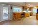 Galley kitchen features a breakfast bar, lots of storage, and natural light from an exterior door at 706 Lynn Ave, New Smyrna Beach, FL 32168
