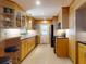 Well-lit kitchen featuring wood cabinets, black appliances, and under cabinet lighting at 706 Lynn Ave, New Smyrna Beach, FL 32168