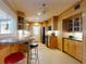 Open kitchen featuring a breakfast bar, wooden cabinetry, and modern appliances for convenient living at 706 Lynn Ave, New Smyrna Beach, FL 32168