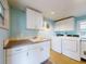 A laundry room features a sink, a washer and dryer set, plus white cabinets with counter space at 706 Lynn Ave, New Smyrna Beach, FL 32168
