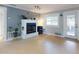Bright living room with a decorative fireplace, large window and access to the patio at 706 Lynn Ave, New Smyrna Beach, FL 32168