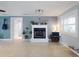 Comfortable living room featuring a fireplace, large windows, and neutral tones at 706 Lynn Ave, New Smyrna Beach, FL 32168