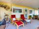 A cozy porch setup with comfortable seating, plants, and natural light creating a relaxing retreat at 706 Lynn Ave, New Smyrna Beach, FL 32168