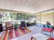 Spacious screened porch featuring ample seating, plants, and scenic views, perfect for relaxation and entertaining at 706 Lynn Ave, New Smyrna Beach, FL 32168