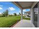 View from the back porch to the well maintained lawn and lake in the distance at 7367 Catania Loop, Clermont, FL 34714