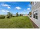 View from the side of a two story home to the backyard and distant lake at 7367 Catania Loop, Clermont, FL 34714