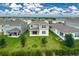 Spacious backyard featuring lush green lawn, patio, sliding glass doors, and views of the lovely home exterior at 7367 Catania Loop, Clermont, FL 34714
