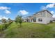 View from the side of a two story home to the backyard at 7367 Catania Loop, Clermont, FL 34714