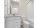 Bright bathroom featuring a white vanity with sleek fixtures, a toilet, and a shower/tub combo at 7367 Catania Loop, Clermont, FL 34714