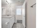 Well-lit bathroom with single vanity, open door to bedroom, and view of the neutral colored walls at 7367 Catania Loop, Clermont, FL 34714