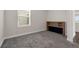 Bedroom with neutral carpet and walls, built-in desk, and view of window at 7367 Catania Loop, Clermont, FL 34714