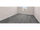 Well-lit bedroom shows ample carpeting space and a bright window providing a beautiful view at 7367 Catania Loop, Clermont, FL 34714