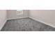 Well-lit bedroom shows ample carpeting space and a bright window providing a beautiful view at 7367 Catania Loop, Clermont, FL 34714