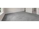 Bedroom with carpet, white trim, and an entrance to an en-suite bathroom at 7367 Catania Loop, Clermont, FL 34714