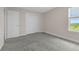Comfortable bedroom features neutral carpeting and white trim, offering a cozy and inviting space at 7367 Catania Loop, Clermont, FL 34714