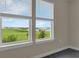 Bedroom window showcasing serene views of a lush green landscape at 7367 Catania Loop, Clermont, FL 34714