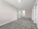 Bonus room with neutral colored carpet, paint, trim and door to hallway at 7367 Catania Loop, Clermont, FL 34714