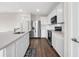 Bright kitchen featuring white cabinets, stainless steel appliances, and quartz countertops at 7367 Catania Loop, Clermont, FL 34714