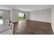 Bright living area with wood flooring leading to a sliding door, offering a scenic view at 7367 Catania Loop, Clermont, FL 34714
