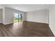 Bright living area with wood flooring leading to a sliding door, offering a scenic view at 7367 Catania Loop, Clermont, FL 34714