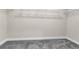 A spacious walk-in closet fitted with wire shelving and neutral carpet at 7367 Catania Loop, Clermont, FL 34714