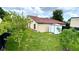 Spacious backyard featuring lush green grass, shed, and trees at 761 Golden Sunshine Cir, Orlando, FL 32807