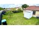 Spacious backyard featuring lush green grass, shed, and privacy fence at 761 Golden Sunshine Cir, Orlando, FL 32807
