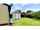 Backyard featuring lush green grass, privacy fence and shed at 761 Golden Sunshine Cir, Orlando, FL 32807
