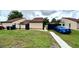 Nice single-story home showing a green lawn and a blue car parked, complemented by a concrete pathway at 761 Golden Sunshine Cir, Orlando, FL 32807