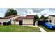 Charming single-Gathering home with a well-manicured lawn and a side entrance, complemented by dark fencing at 761 Golden Sunshine Cir, Orlando, FL 32807