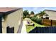 Landscaped side yard with privacy fence, greenery, and walkway, offering a serene outdoor setting at 761 Golden Sunshine Cir, Orlando, FL 32807