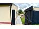 Side yard featuring a dark wood fence and concrete pathway, creating a secluded outdoor space at 761 Golden Sunshine Cir, Orlando, FL 32807